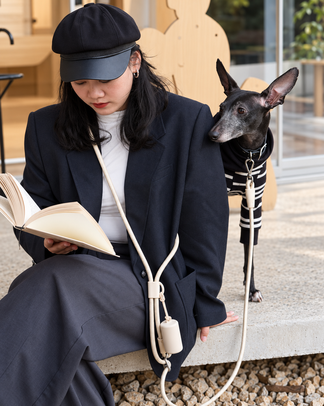 Cream Mayfair Pets multi-way rope lead styled crossbody while relaxing with a dog